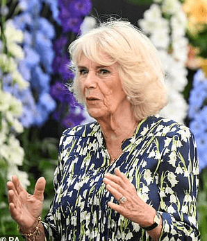 Queen Camilla exudes a radiant presence as she graces the Chelsea Flower Show, accompanied by King Charles.